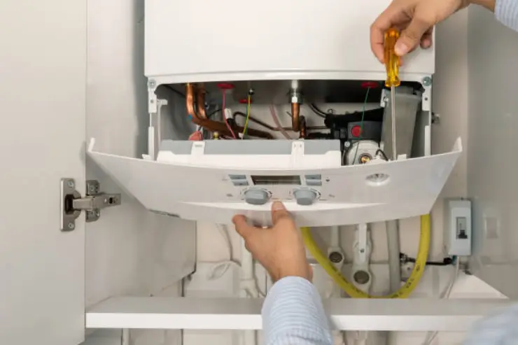 Closing the service panel of a modern, high-efficiency gas or electric heating unit.
