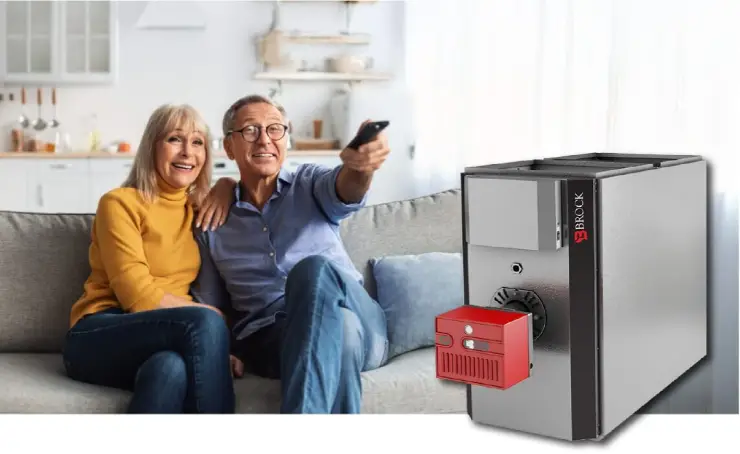 Happy couple on a sofa with a modern Brock heating system unit.